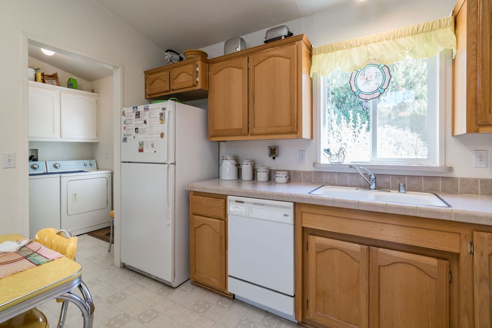 Kitchen with dishwasher and Utility Room with washer & dryer.

