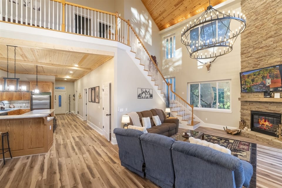 Stone fireplace and cozy seating area with Smart TV