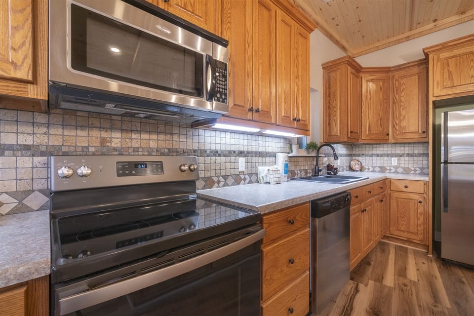 Fully stocked kitchen with stainless steel appliances and plenty of space to cook