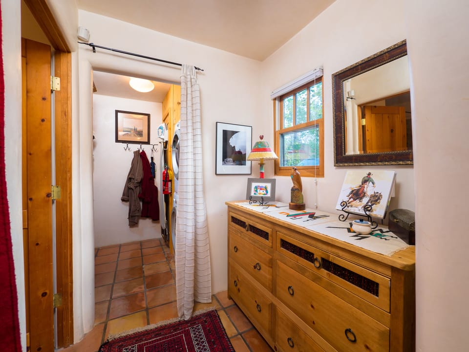 Master suite dressing area, closet, full-size stacking W/D and garden view 