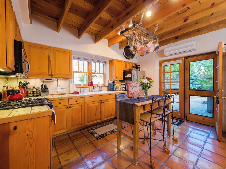 Kitchen's French doors leading out to the dining ramada, fire table & grill