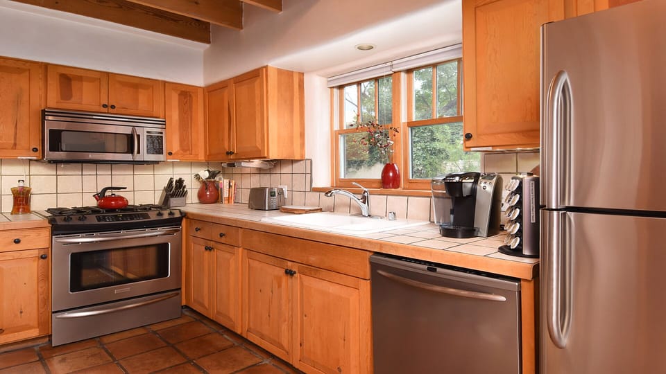 Stainless GE Monogram appliances grace the kitchen