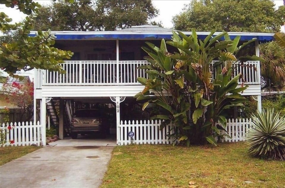 Front view of screened porch and parking