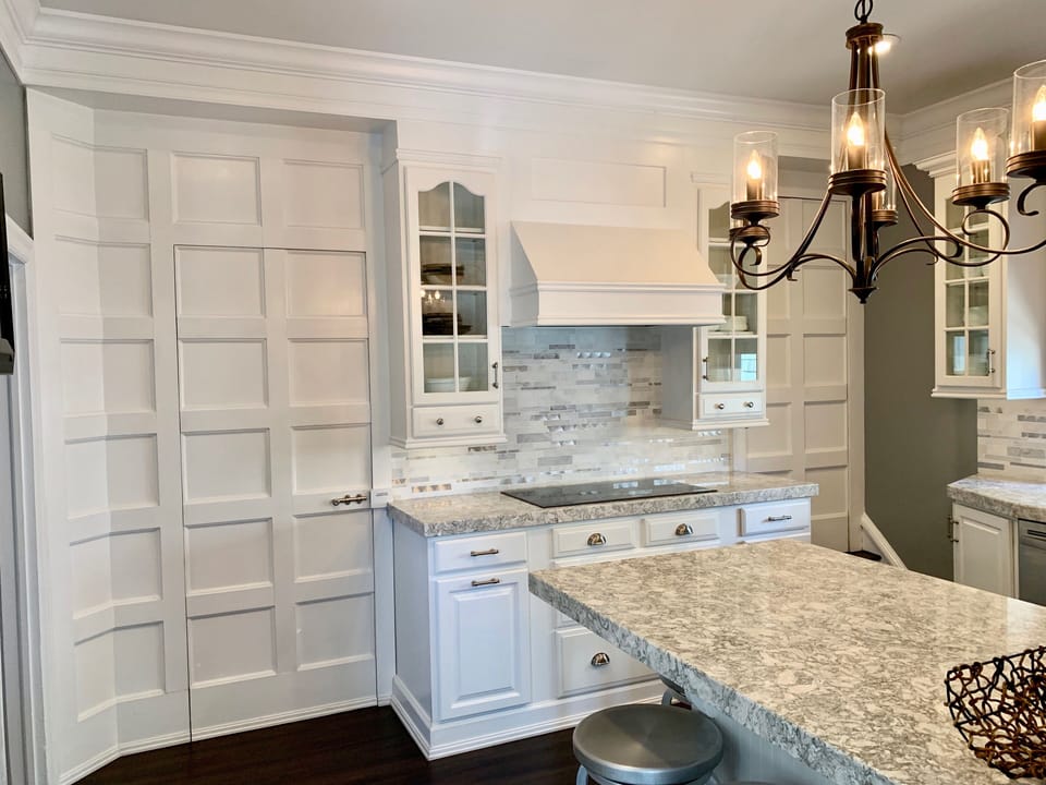 Hidden doorway through the paneled wall leads to the laundry room/basement