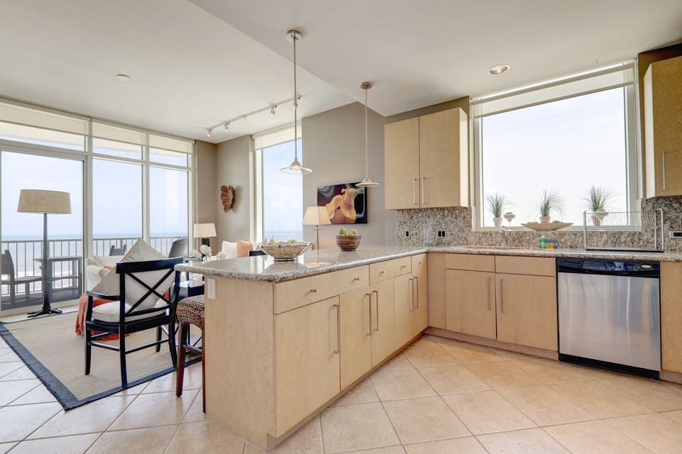Amazing kitchen fully stocked with cooking utensils and stainless steel appliances!