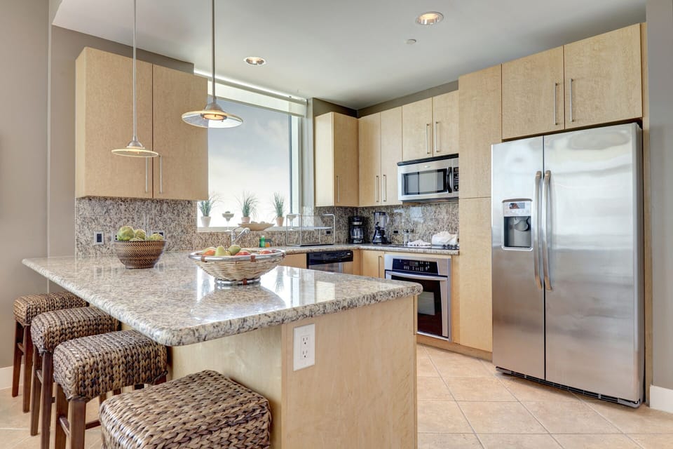 Amazing kitchen fully stocked with cooking utensils and stainless steel appliances!