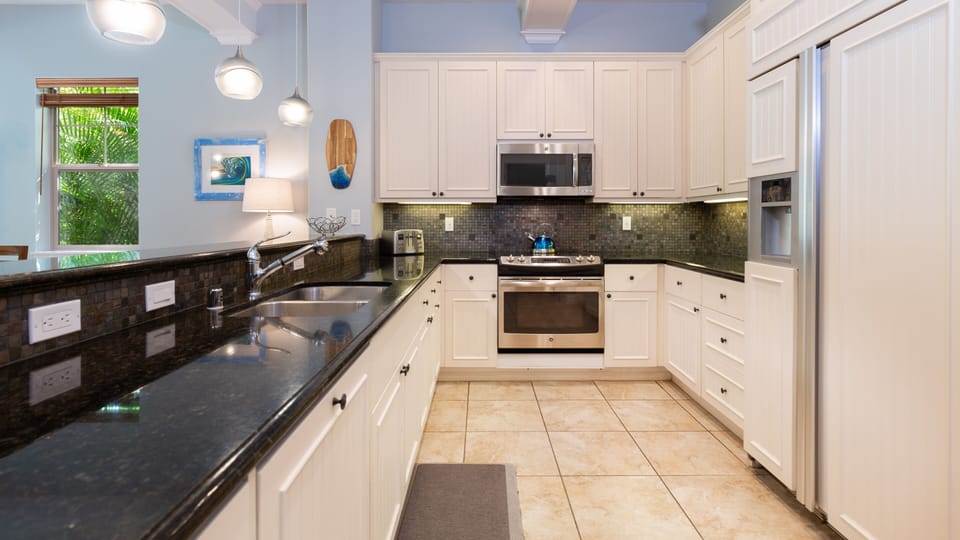 Gourmet Kitchen with a nice assortment of spices, oil and vinegar provided for meal prep.