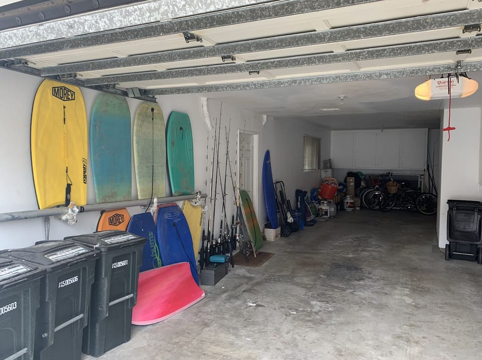 Garage with Bikes, Boogey Boards, Fishing Poles. and Two Parking Spaces