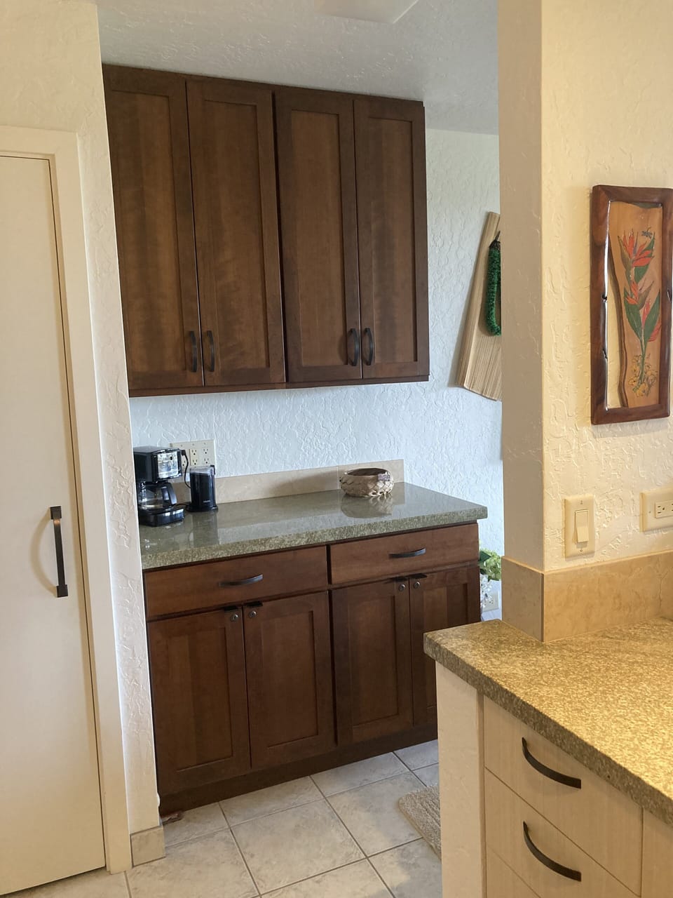 Coffee bar counter with pantry to the left.