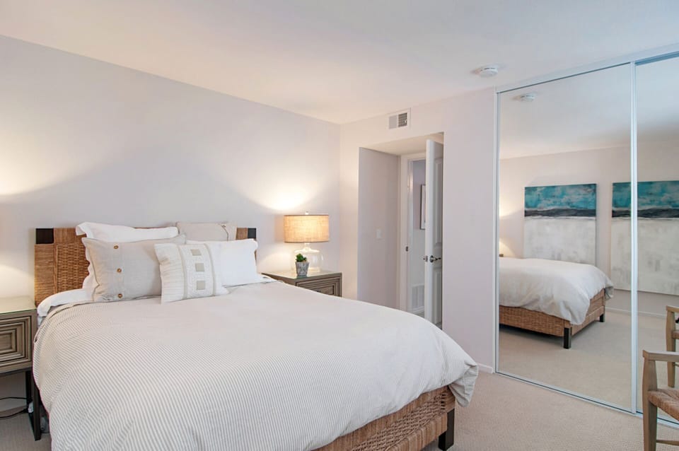 Second bedroom quietly positioned with large mirrored closet
