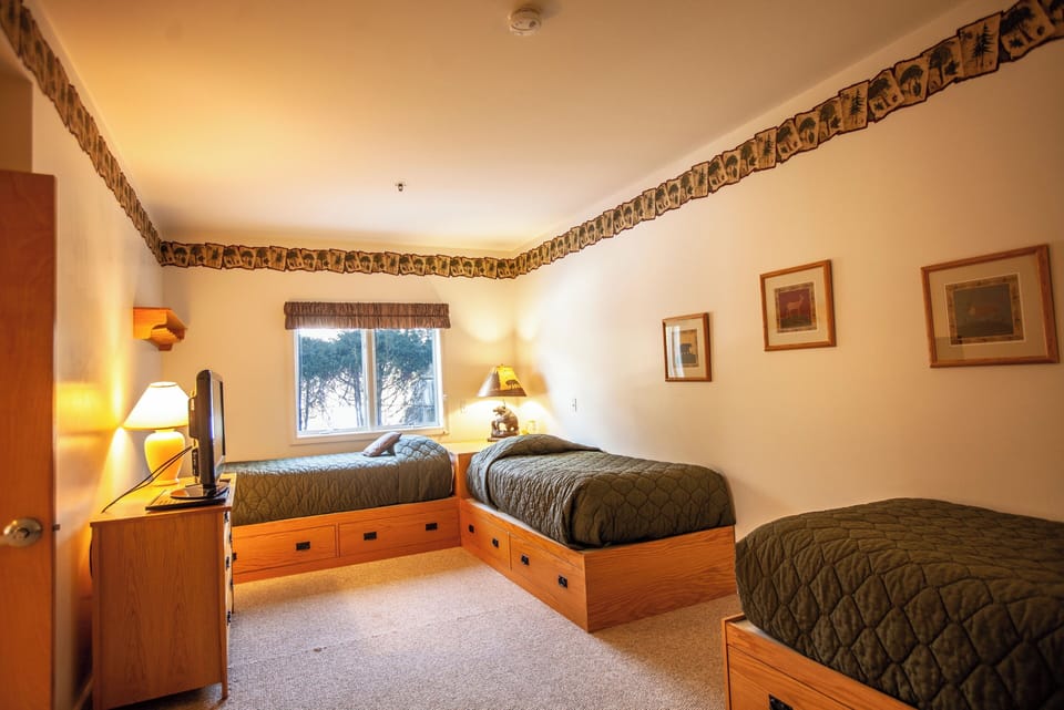 Three twin beds in one of the guest bedrooms