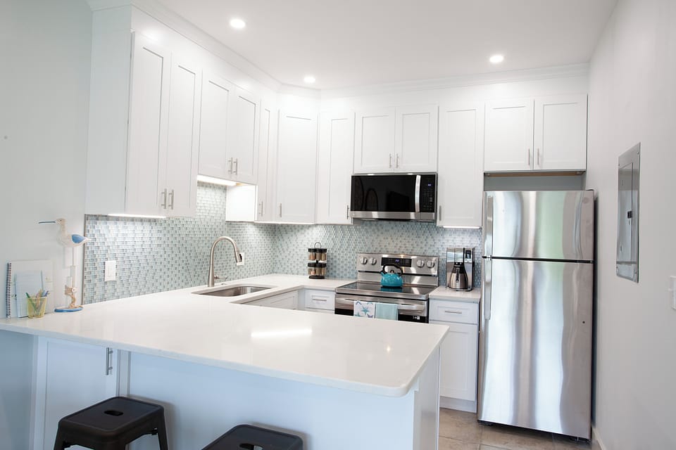 Updated kitchen with quartz countertop, tile backsplash and new appliances