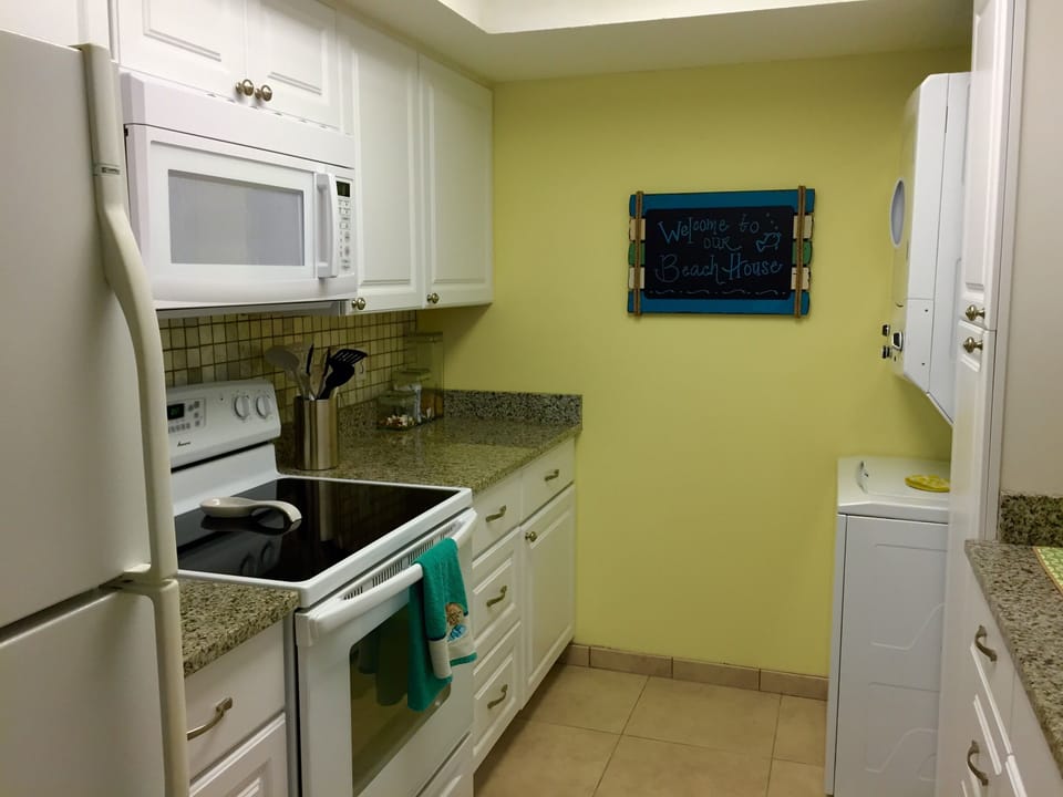 Kitchen, newly renovated, new range, cabinets, washer & dryer.