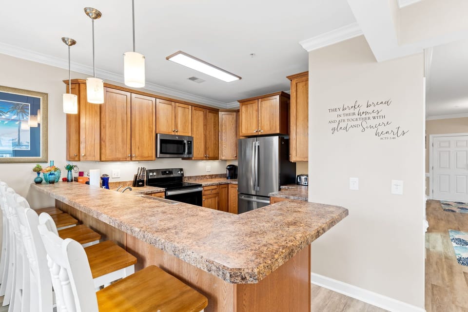 Kitchen and high bar view.  5 barstool seats in addition to dining table for 6.