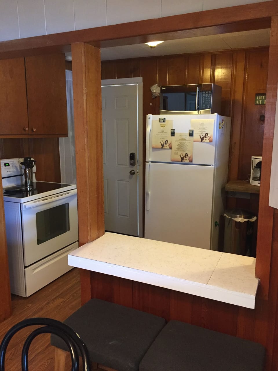 Large fridge and glass top stove for food storage/prep/cooking.