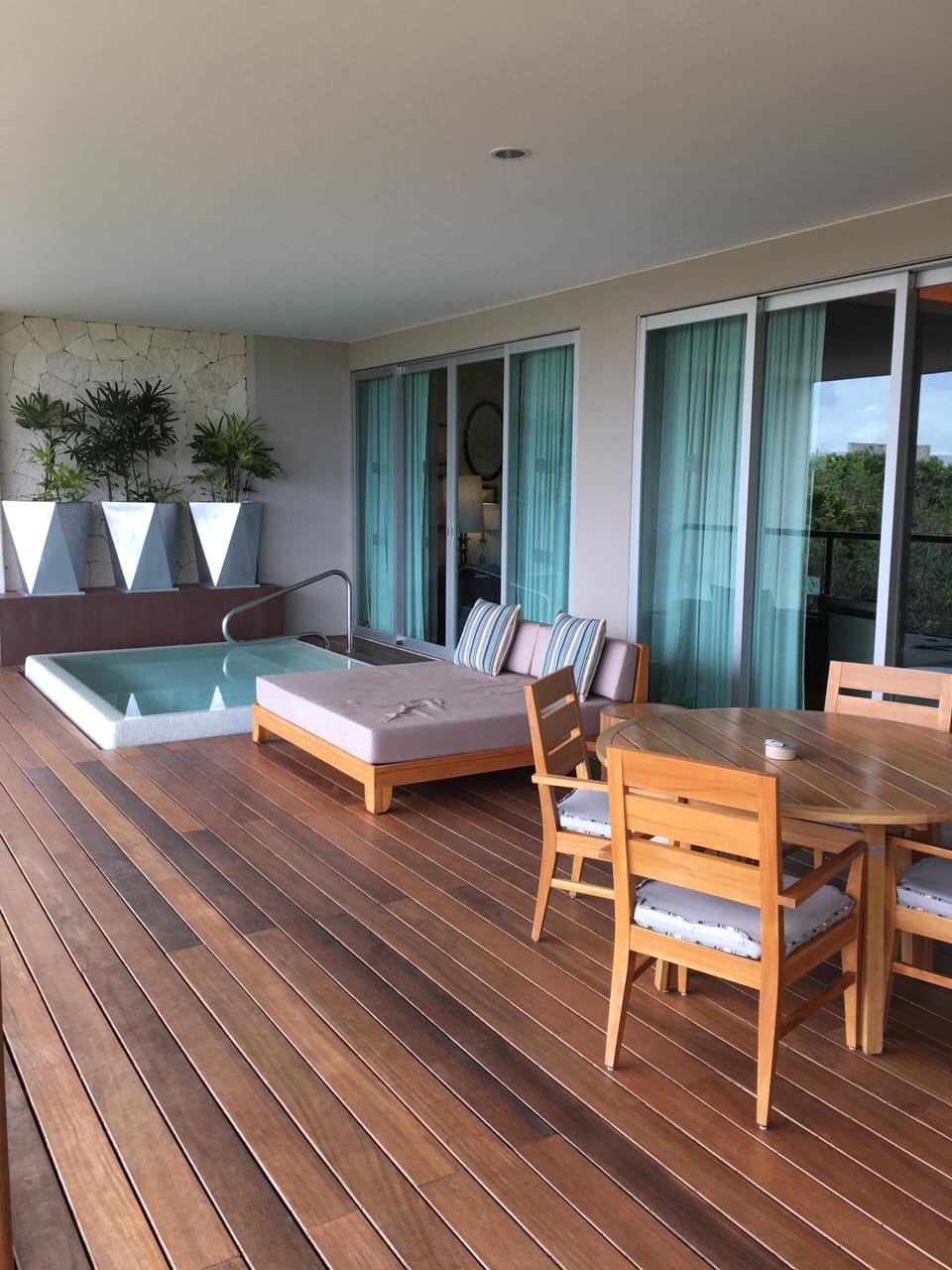 Wrap around patio with heated dipping pool, king lounger, and place to eat.