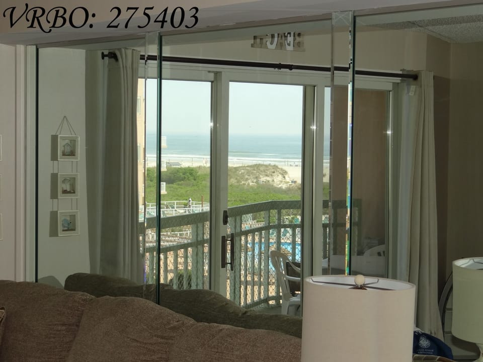 View of ocean through mirror from dining and living area
