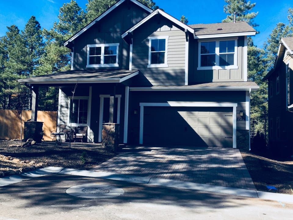 Front view of home, which is on a corner lot in a small, squarish cul-de-sac. 