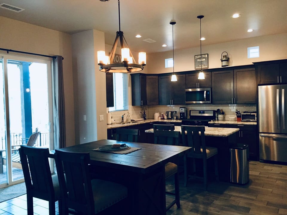 Kitchen and dining room area, opened up to the living room, with forest views.
