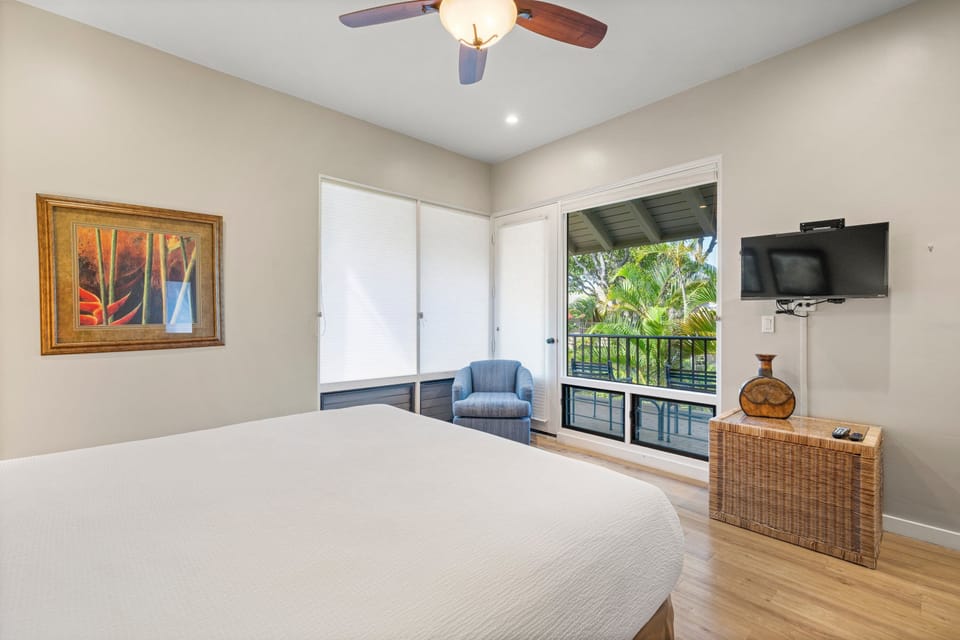 Spacious bedroom with a plush size bed and tv entertainment