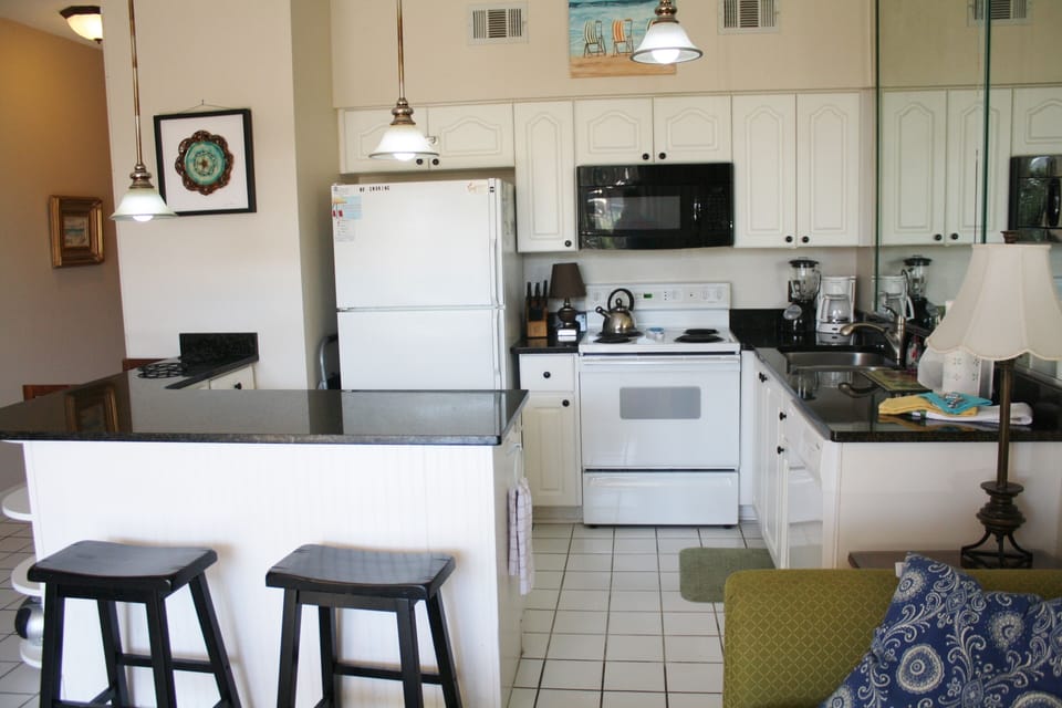 Closer view of kitchen-A plethora of countertop & cabinet space/cooking utensils
