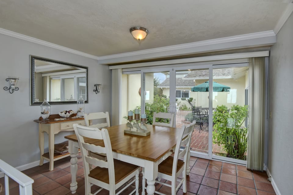 dining room with ocean views and easy access to kitchen, living, backyard