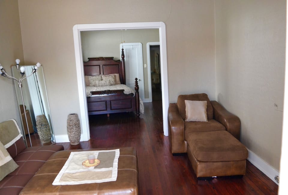 Living room with French doors leading to the first bedroom. 