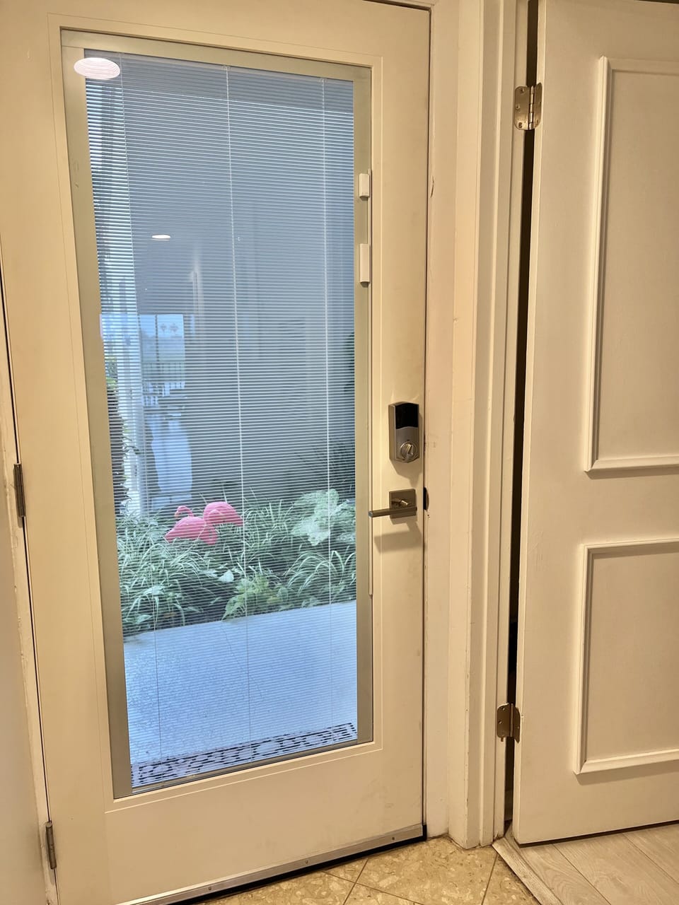 Window in front door has internal shade that can be open or fully closed.