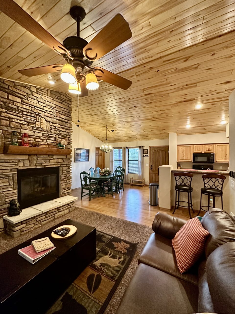View from the living room of the kitchen, countertop eating area and dining room