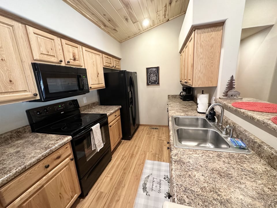 Kitchen w/ oven, microwave and dishwasher 