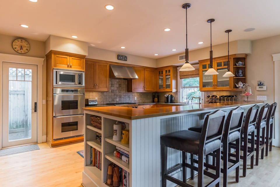 kitchen with dual oven, microwave and 6 burner gas stove