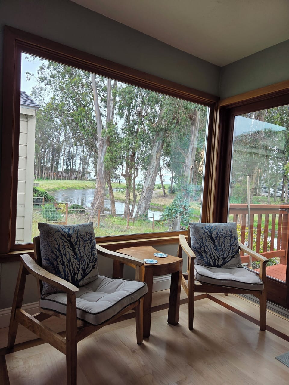 View from living room with lake view and peek of the ocean.