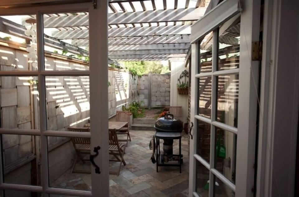Small private backyard patio with BBQ. Outside shower too!