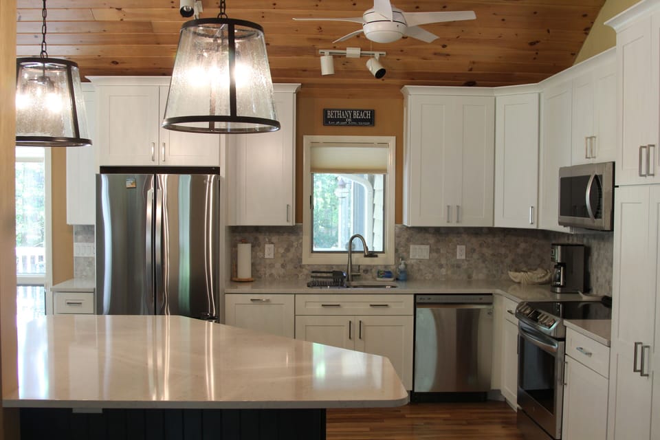 kitchen with large island (4 stools), pantry, stainless appliances