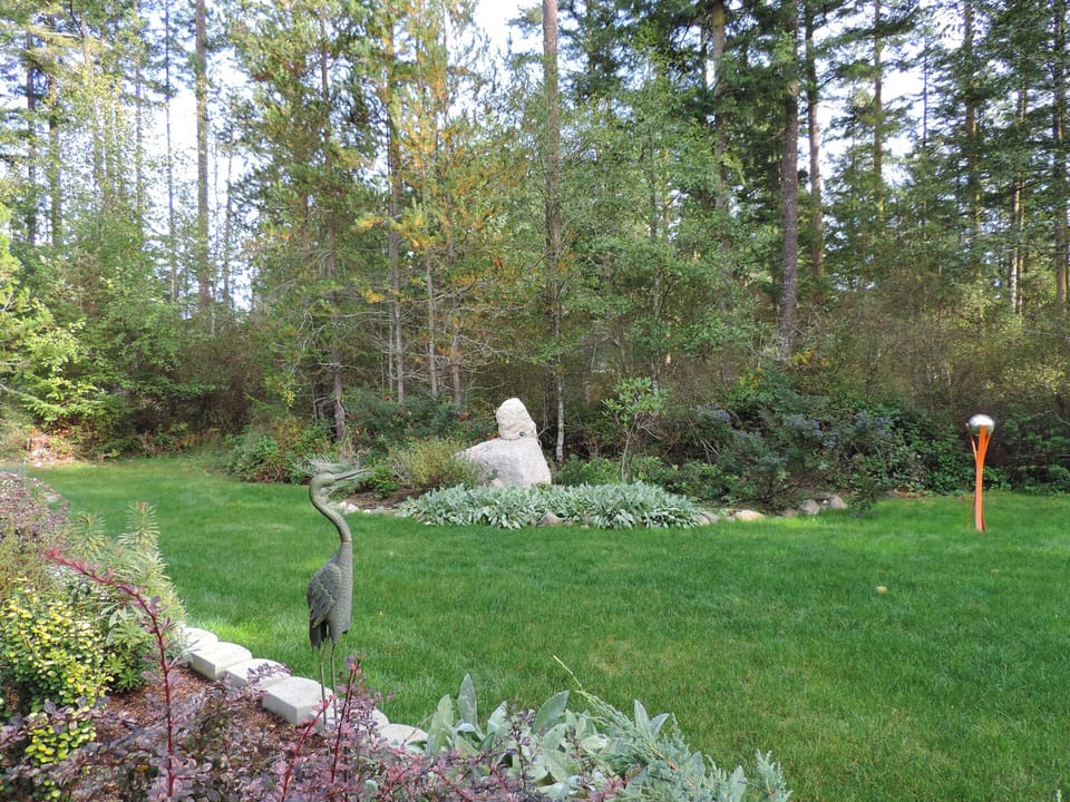 Rock sculpture & flower garden at forest's edge
