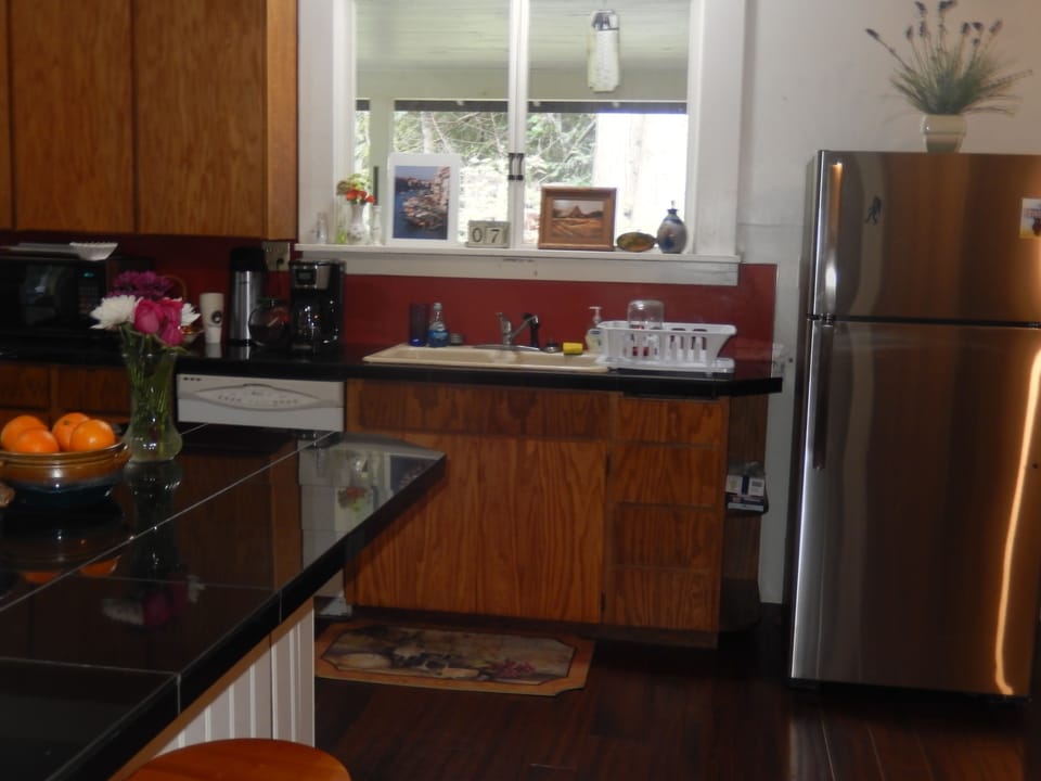 Kitchen has stainless steel oven/stove, refrigerator, microwave & dishwasher...