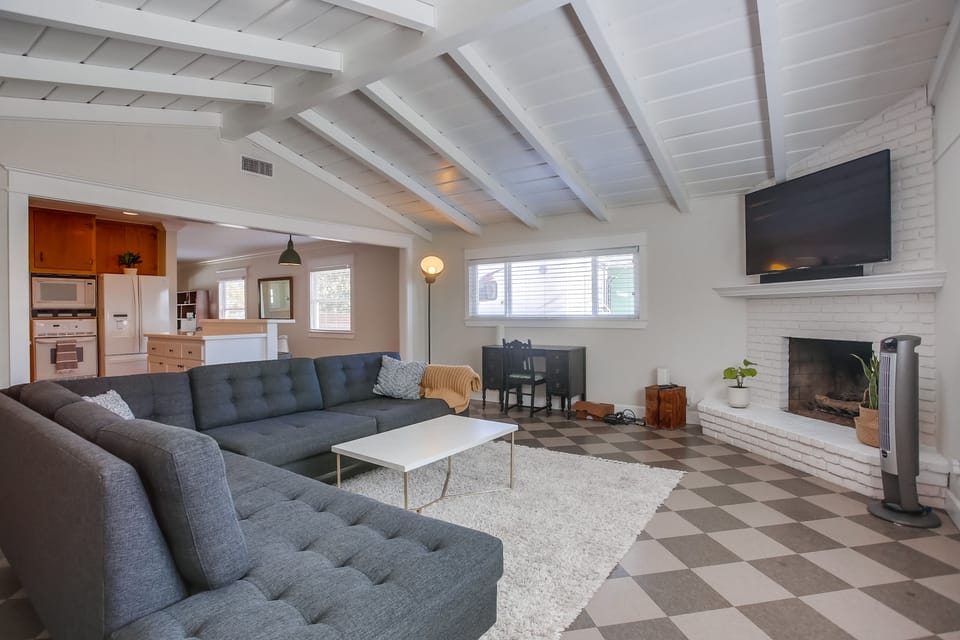 BIG couch, room for the whole family. The door in the picture leads to the fully fenced in back yard and outdoor eating area.

The fireplace is to not be utilized.
