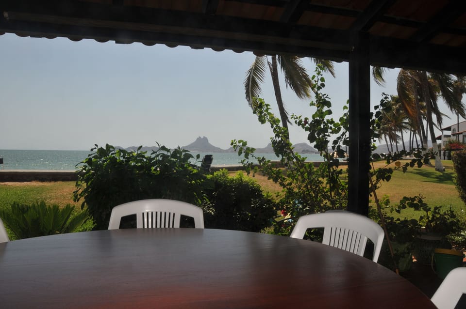 Beach porch dining table in shade under the roof.