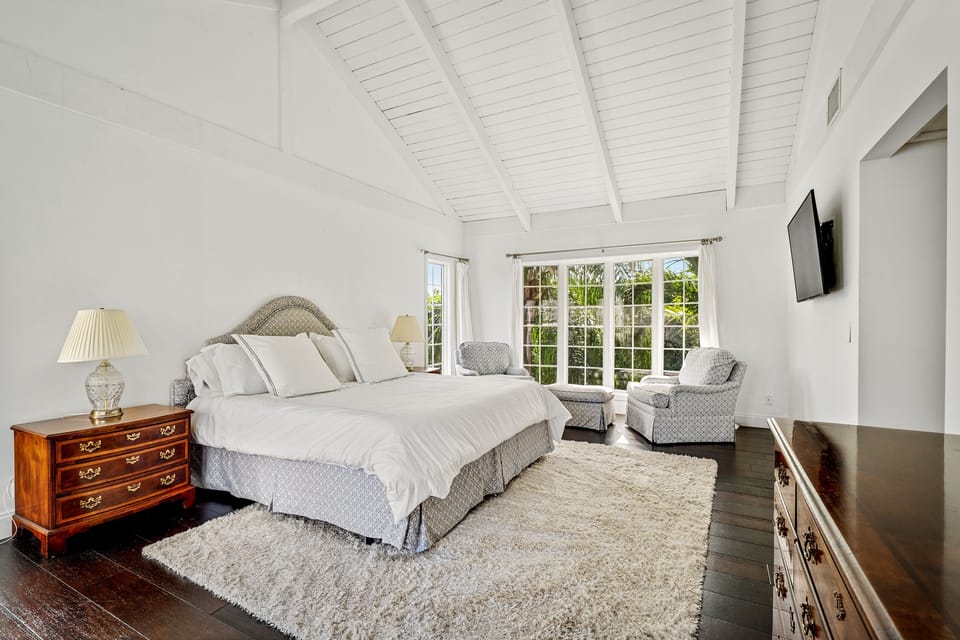 Master bedroom with king-sized bed and smart HDTV and seating area