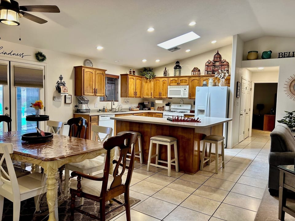 Dining area table seats up to 8! There are 4 bar stools at the center island-