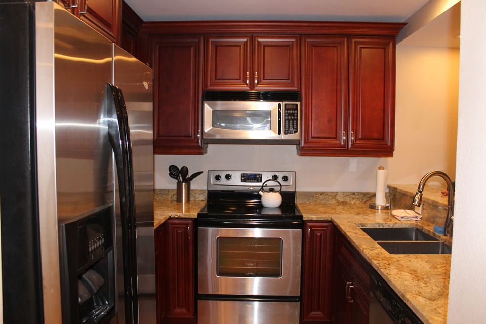 Full kitchen with full size fridge, stove/oven, dishwasher, and microwave