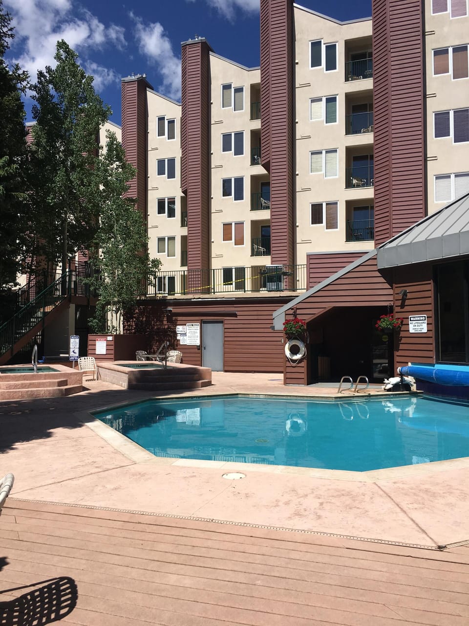 Outdoor pool area includes a common grill