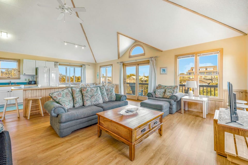 Relax in your spacious living room with soaring ceilings and panoramic windows that flood the space with natural light.