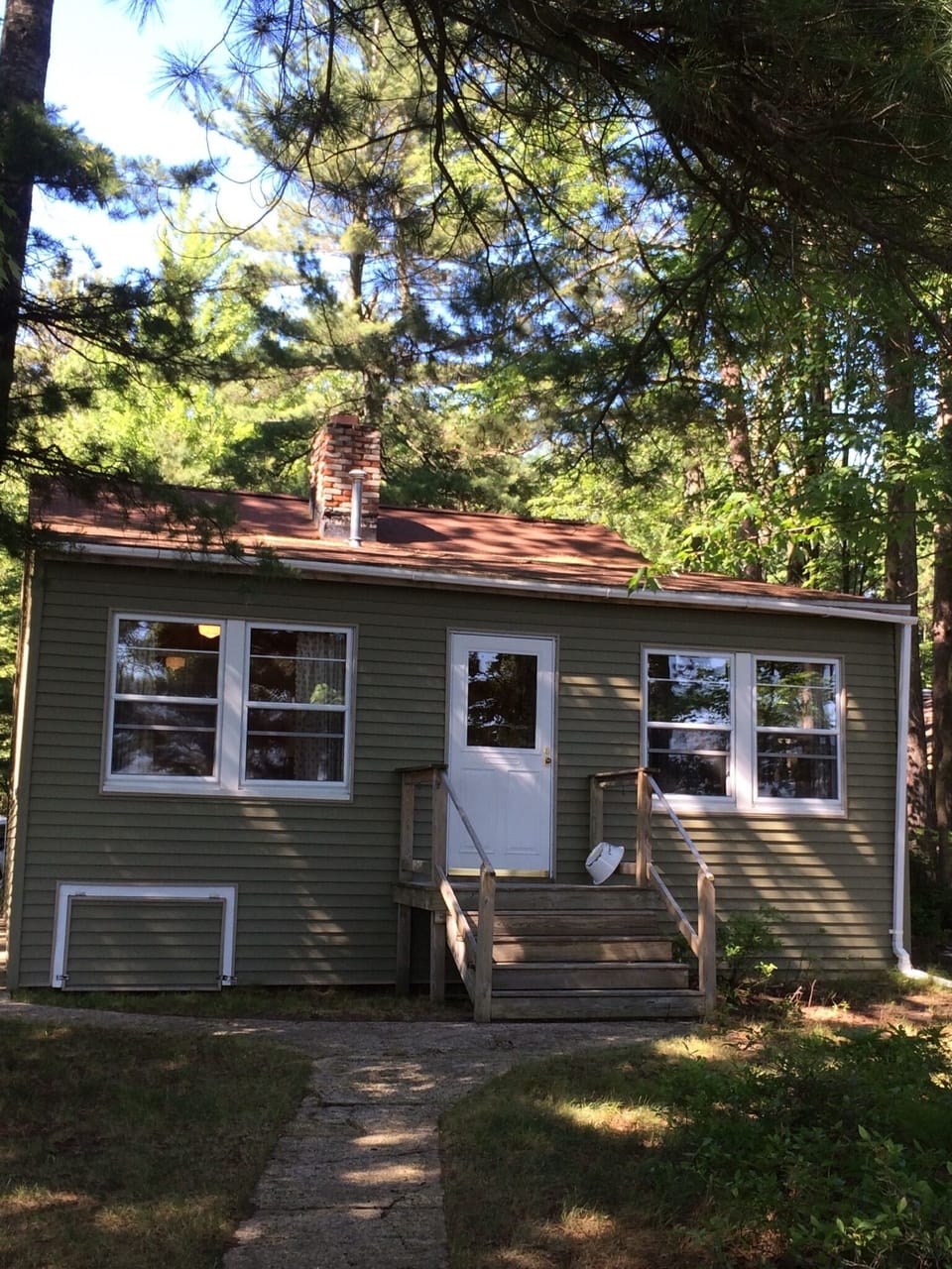 Front of cottage, just a few steps down to patio and expansive beach!