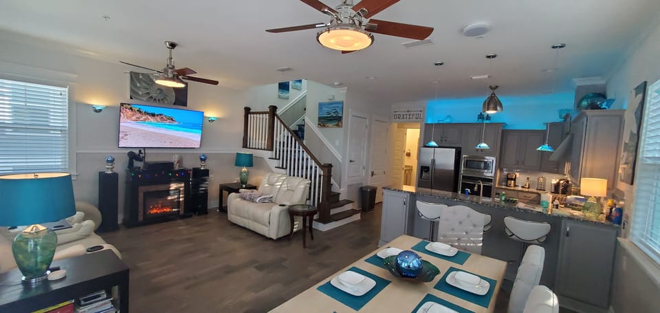 Great room. Power reclining sofas, 65 HD 4K TV, ceiling fans, fireplace