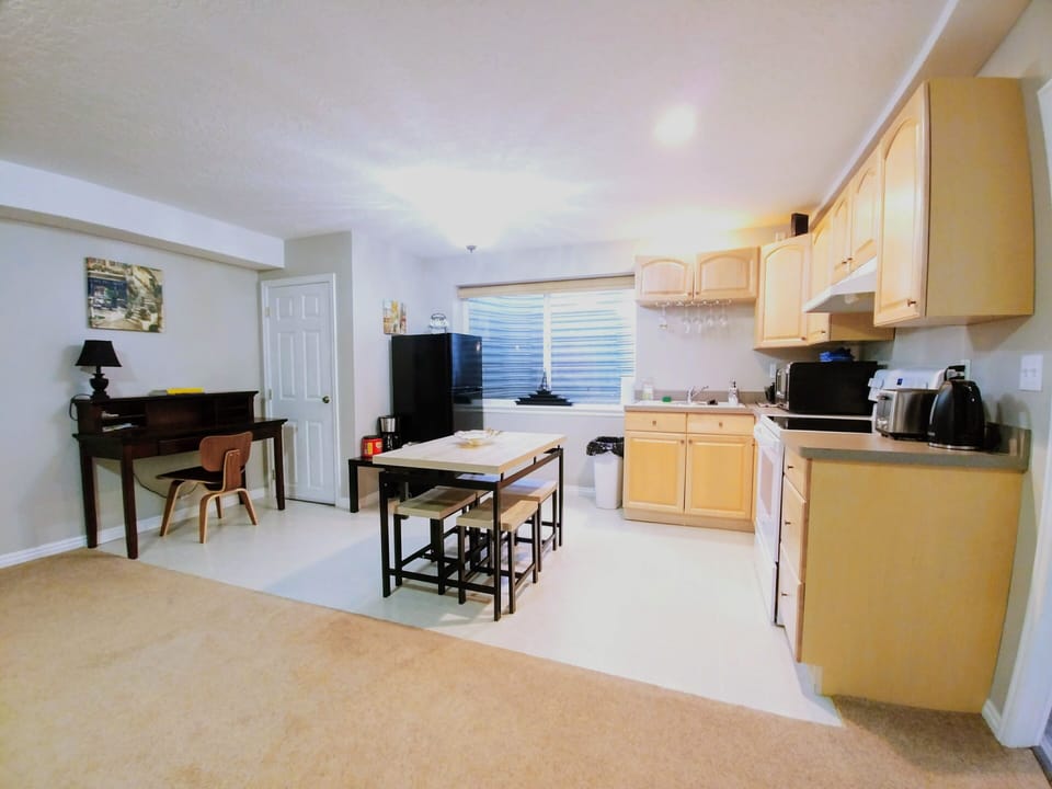 Kitchen with microwave, brand new stove, oven, fridge, kettle, toaster, pots...