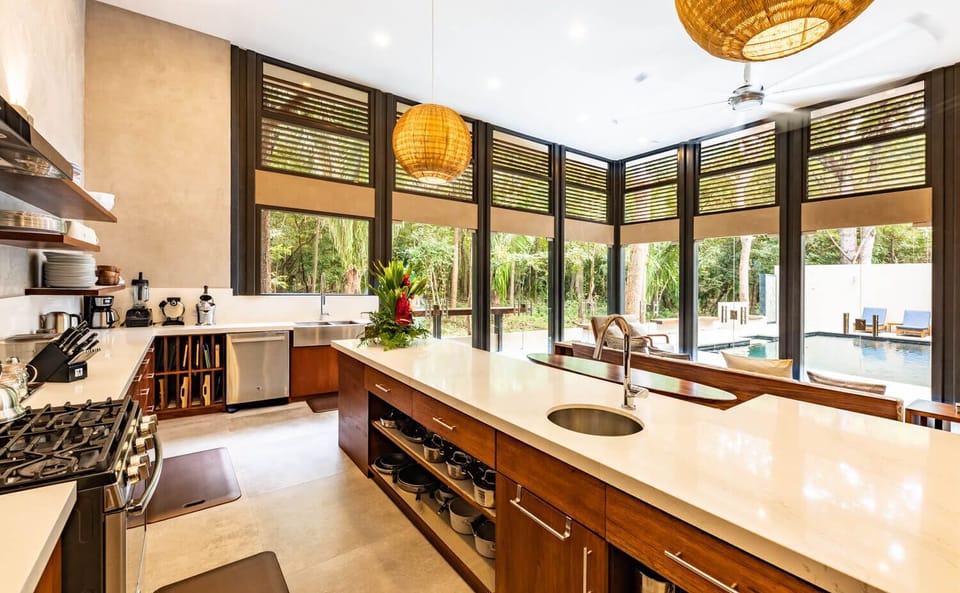 Jungle & Pool views from the dream kitchen. Island with built in breakfast nook