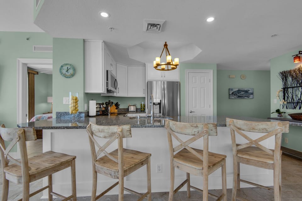 Kitchen with granite countertops & 4 bar stools.