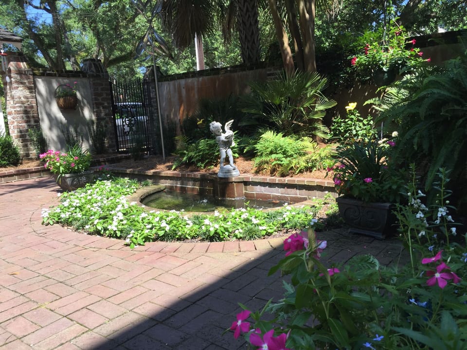 Enjoy the flower surrounded fountain in the private gated courtyard. 