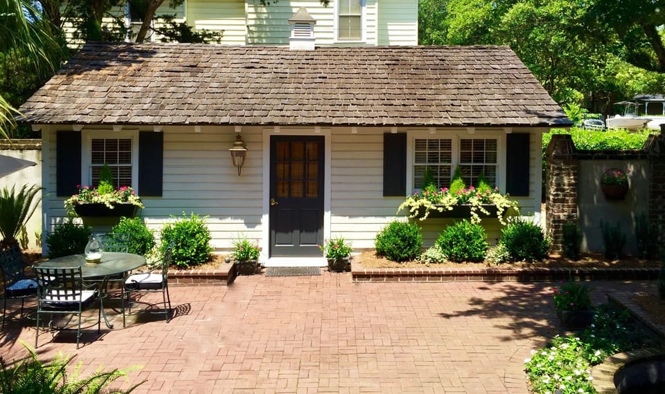 The cottage sits in a beautiful gated courtyard with a peaceful pond and fountain.